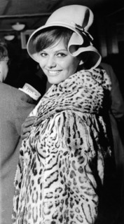Claudia CARDINALE in a leopard coat at the airport, London 1962
