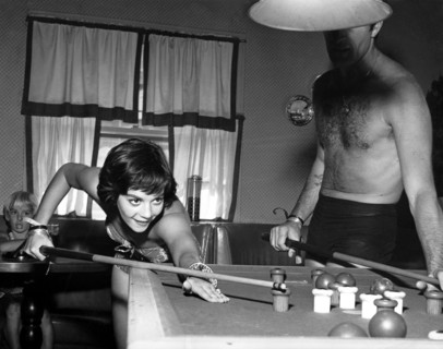 Natalie WOOD and Hugh O'BRIAN playing a game of billiards