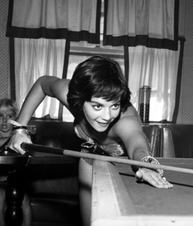 Natalie WOOD playing a game of billiards