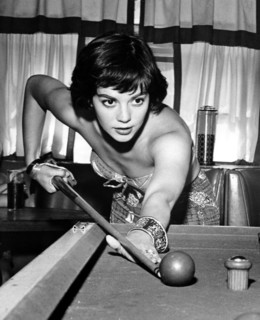 Natalie WOOD playing a game of billiards