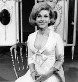 Bibi JOHNS sitting on a chair