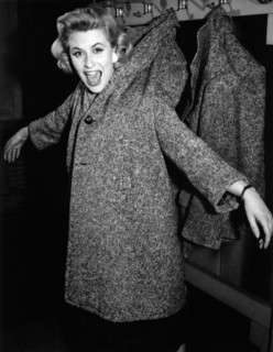 Bibi JOHNS hangs on a coat rack