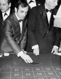 Charles AZNAVOUR at 'Maxim's' playing roulette, Paris circa 1960s