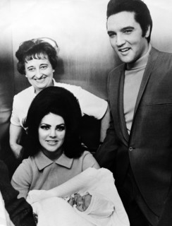 Elvis PRESLEY with his wife and daughter leaving the Baptist Hospital, 1968