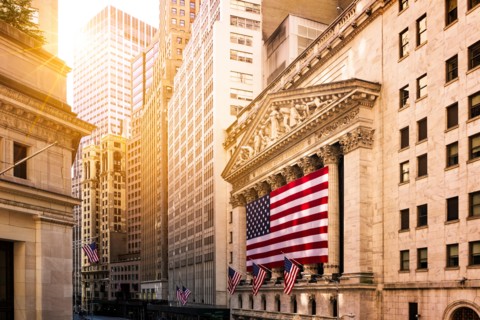 Famous Wall street and the building in USA, New York Stock Exchange with patriot flag