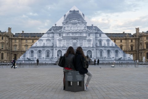 Louvre museum pyramid covered with thousands of paper sheets to make it disappear with an optical illusion.