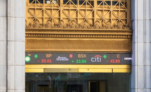 Entrance to New York Stock Exchange at 11 Wall Street, showing digital ticker tape display
