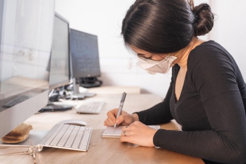 Coronavirus. Woman at the office sick with mask for corona virus. Business women wear masks to protect and take care of their health. Home working