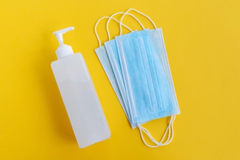 Hand Sanitizer and 3 layer surgical mask - Corona Virus Covid 19 concept - Health and care.