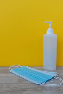 Hand Sanitizer and 3 layer surgical mask - Corona Virus Covid 19 concept - Health and care.