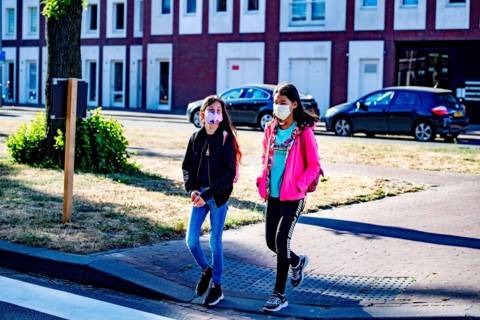 Children walk to school while wearing face masks as a precaution against the spread of coronavirus.School children will go back to primary school full-time beginning 8th June and will have to adapt to...