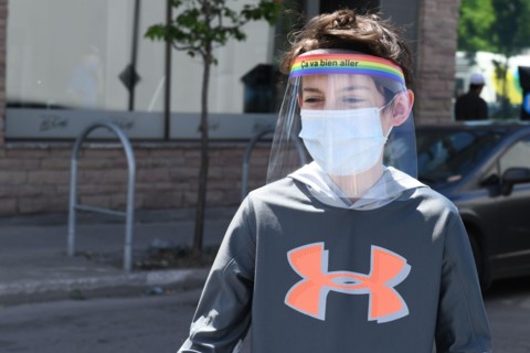 Boy wearing protective face masks and face shields during Covid-19 Pandemic in Montreal Canada (Model released)