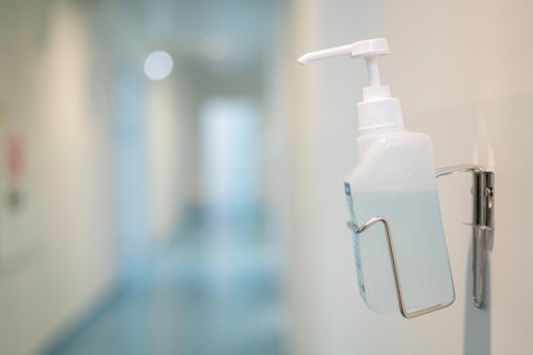 Hand sanitizer gel bottle on the wall of a public space