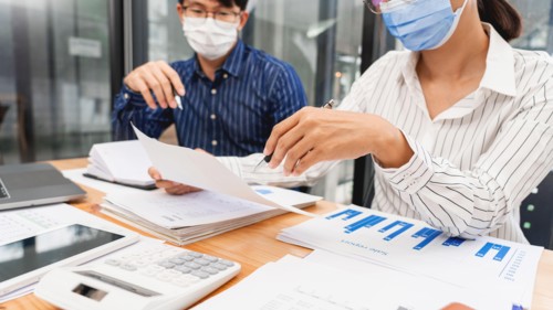 Group of Teamwork Asian business People Wearing Protective face Mask In Office During Pandemic coronavirus COVID-19, New Normal and Social distancing