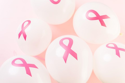 White latex balloos with pink reibbons.