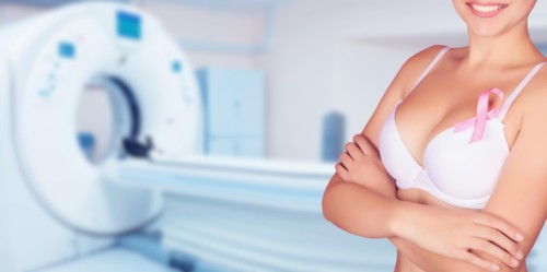 Breast cancer prevention concept. Background of female breasts in a bra in the office of mammography.
