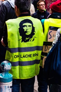Marseille, France - January 25, 2020: A protester wearing a yellow vest during a 'marche de la colère' ('the march of anger') concerning housing issue
