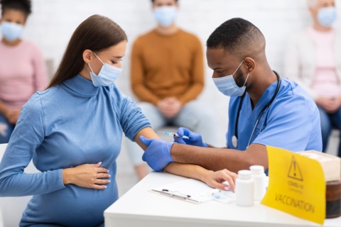 Pregnant Lady In Mask Getting Vaccinated Against Coronavirus In Hospital