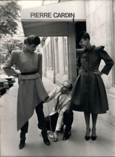 Jul. 22, 1979 - Pierre Cardin and his two models that are wearing pieces from his latest collection. On the left, she is wearing a suit jacket with a squared shoulder and an asymmetrical skirt over fi...