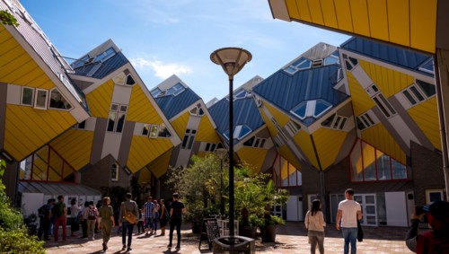 ROTTERDAM, NETHERLANDS - AUGUST 13, 2017 : Group of tourists in the yard of Cube houses or Kubuswoningen in Dutch are a set of innovative houses desig