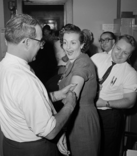 Woman at a health clinic gets a flu shot in Chicago, ca. 1960.