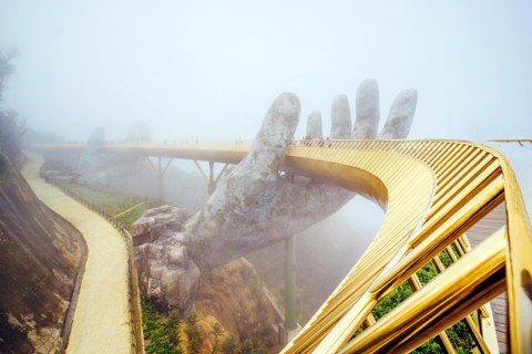 Danang , Vietnam. View in Fog of the Golden Bridge on Ba Na Hills in Da Nang on rainy day.