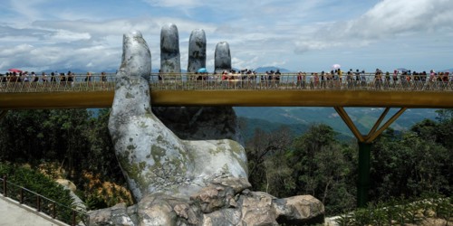 Da Nang, Vietnam - August 18, 2018: Tourists in the Golden Bridge. The Golden Bridge is a 150 m long pedestrian bridge in the Ba Na Hills in Da Nang.