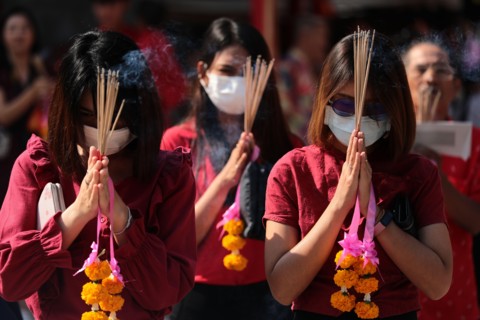 Women pray while wearing dust masks during the celebration at Leng Noei Yi Temple in Chinatown, Bangkok.The Lunar New Year, also known as Spring Festival in China marks the beginning of the Year of th...