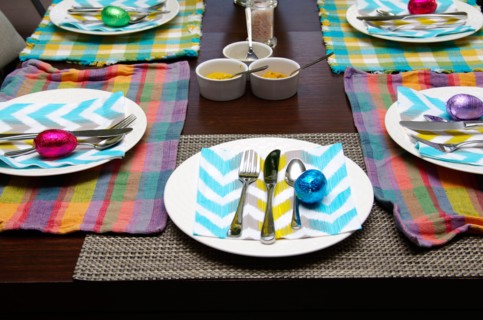 An Easter table with colourful pastel place settings.