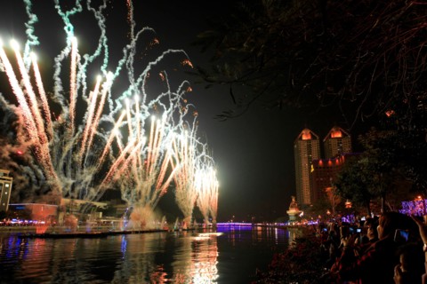 Kaohsiung, Taiwan. People watching the fireworks for the chinese new year at the Love River of Kaohsiung. The Chinese New Year is an important Chinese festival celebrated at the turn of the Chinese ca...