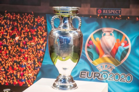 Original UEFA European Championship Trophy with stadium background and logo EURO 2020