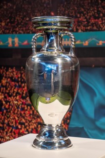 Original UEFA European Championship Trophy with stadium background, vertical