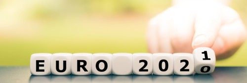Hand turns dice and changes the expression "Euro 2020" to "Euro 2021".