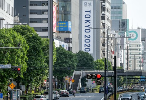Tokyo, Japan. 09th May, 2021. Tokyo 2020 banner seen on a building facade close to the New National Stadium as protesters gather ahead of the demonstration against the Tokyo Olympics. With less than 3...