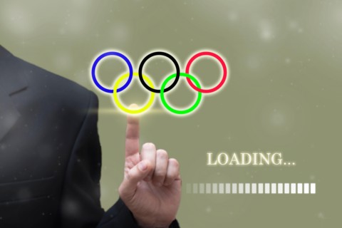 TOKYO, JAPAN, MAY. 23. 2021: Businessman hand pointing Loading olympic Games Rings digital loading bar. Summer olympic game background concept, Tokyo