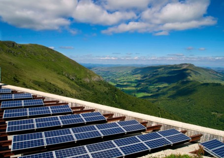 Solar farm with solar panels array in rural Cantal, Auvergne, France, Europe