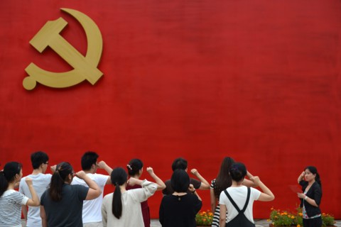 Chinese communists party members take an oath in front of the party flag sign at a  Party Memory Mesume as part of celebrations for the July 1 Chinese Communist Party's 94th anniversary in JiaXing, Zh...