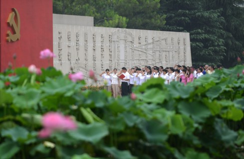 Chinese communists party members take an oath in front of the party flag sign at a Party Memory Mesume as part of celebrations for the July 1 Chinese Communist Party's 94th anniversary in JiaXing, Zhe...