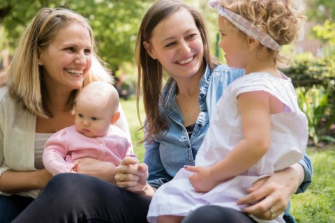 Caucasian mothers and daughters smiling in park