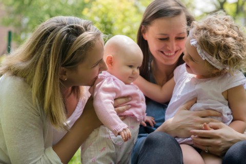 Caucasian mothers and daughters playing in park