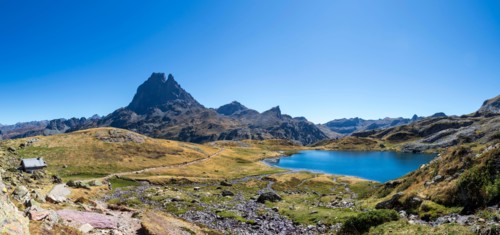 Pic du Midi d'Ossau mountain and Lac Gentau mountain lake in Ossau Valley, iconic symbol of the French Pyrenees, protected area of Pyrenees National P