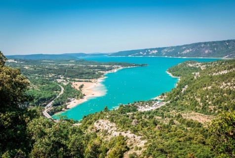 View of a turquoise lake and the surrounding forests