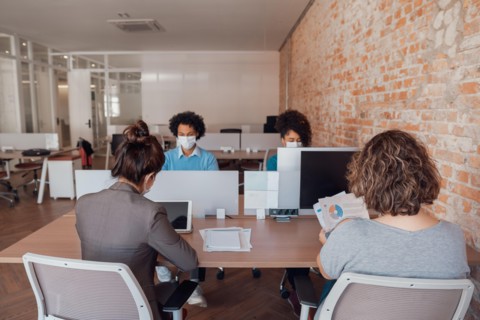 business colleagues working and typing on laptop and tablet in office workspace