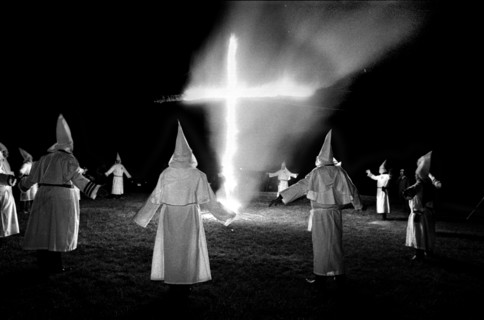 Members of the KKK circle a cross lighting in Rumford Me during rally in the small town Maine town. The Klan had been active in Maine in the 1920's and 30's , This group of Klansmen openly invited the...