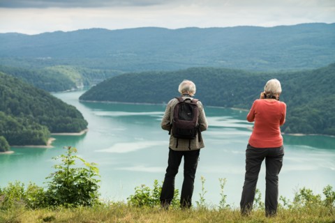 Tourists on the viewpoint on the Lake Vouglans, France, Europe.