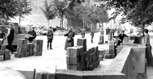 Building the Berlin Wall under armed guard, Berlin, Germany, 1961.