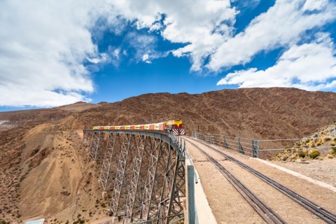 Train to the clouds (tren a las nubes) crossing La Polvorilla bridge in the Altiplano 4.200 meters/13800 feet high, Salta Province, Argentina
