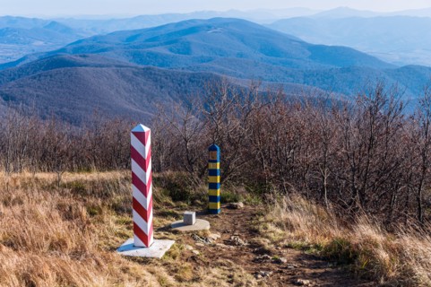 Border markers on a Polish-Ukraine boundary. The Polish eastern border, is also the border of the European Union and NATO. In the background mountains