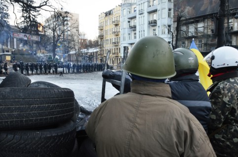 Kiev, Ukraine. 02nd Feb, 2014. Protesters look towards a line of police from behind their makeshift barricade. The so-called EuroMaidan demonstrations began after plans for closer integration with Eur...