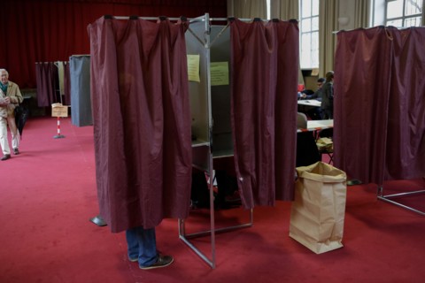 Paris, France. 7th May 2017. A voter makes his decision inside the voting booth. Around 47 Million French people are called to the ballot boxes to elect the next President of France. The independent c...